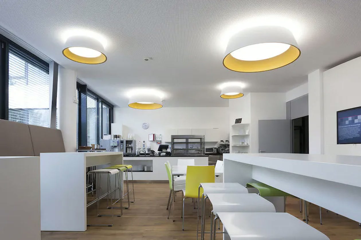 A bright staff kitchen and lunchroom, tables wiped down and floors finished
